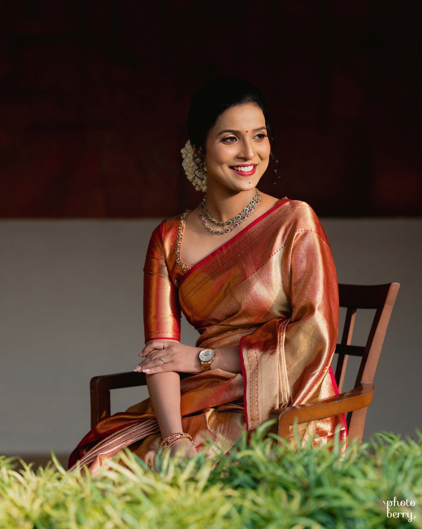 A bride in a copper saree captured in a quiet portrait